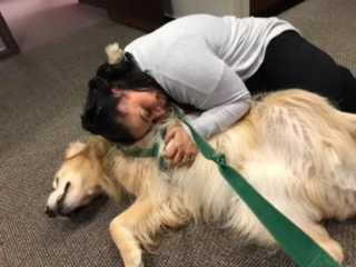 Person lying down with dog